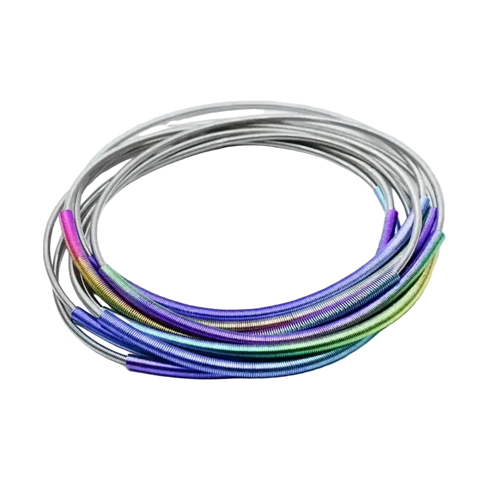A coiled set of metallic guitar strings with a vibrant rainbow iridescent finish, resting on a clean white background.