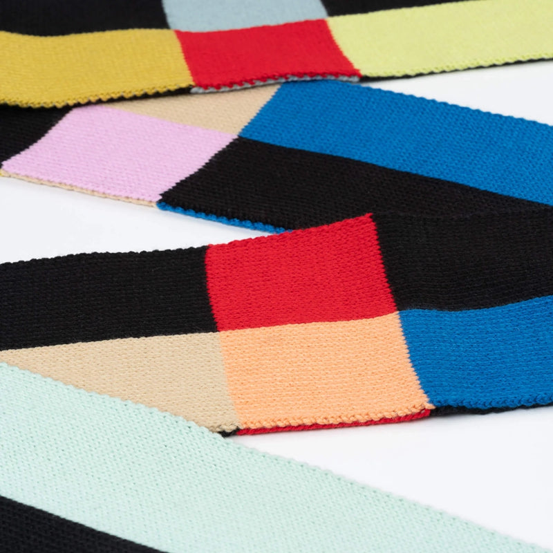 Colorful geometric patterned fabric swatches in various colors.